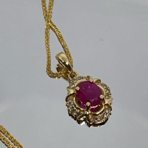 Colgante de Oro con Rubí Oval y Halo de Diamantes Champagne